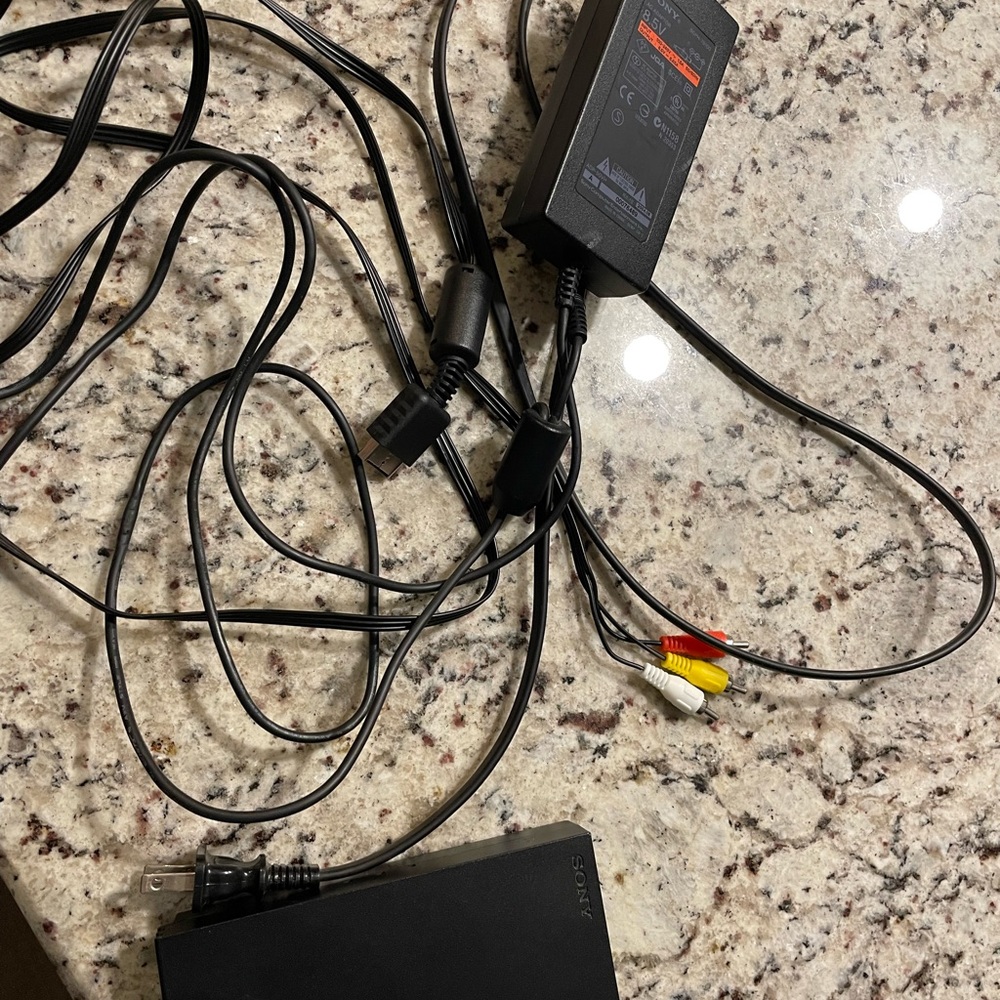 PlayStation 2 with 2 controllers and wires